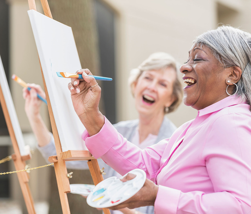 Senior lady painting and smiling