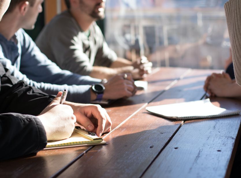 Group of people taking notes at a table