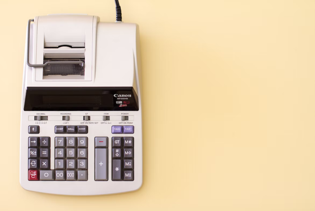 Old fashioned large calculator on table