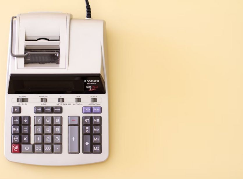 Old fashioned large calculator on table