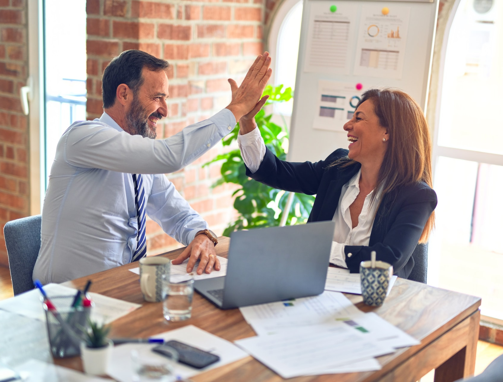 Coworkers high-fiving each other