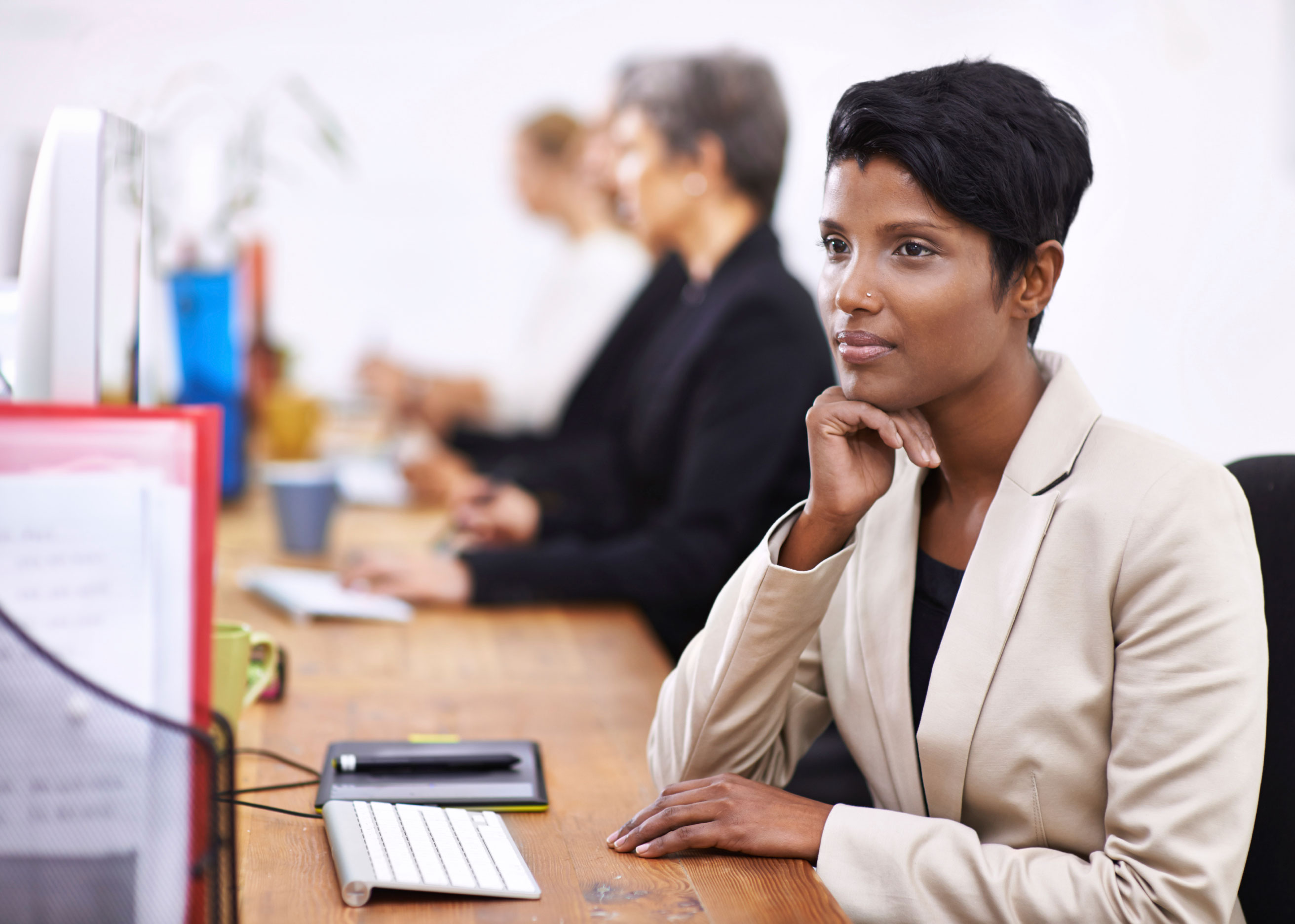 Woman sitting at a desk looking at a screen