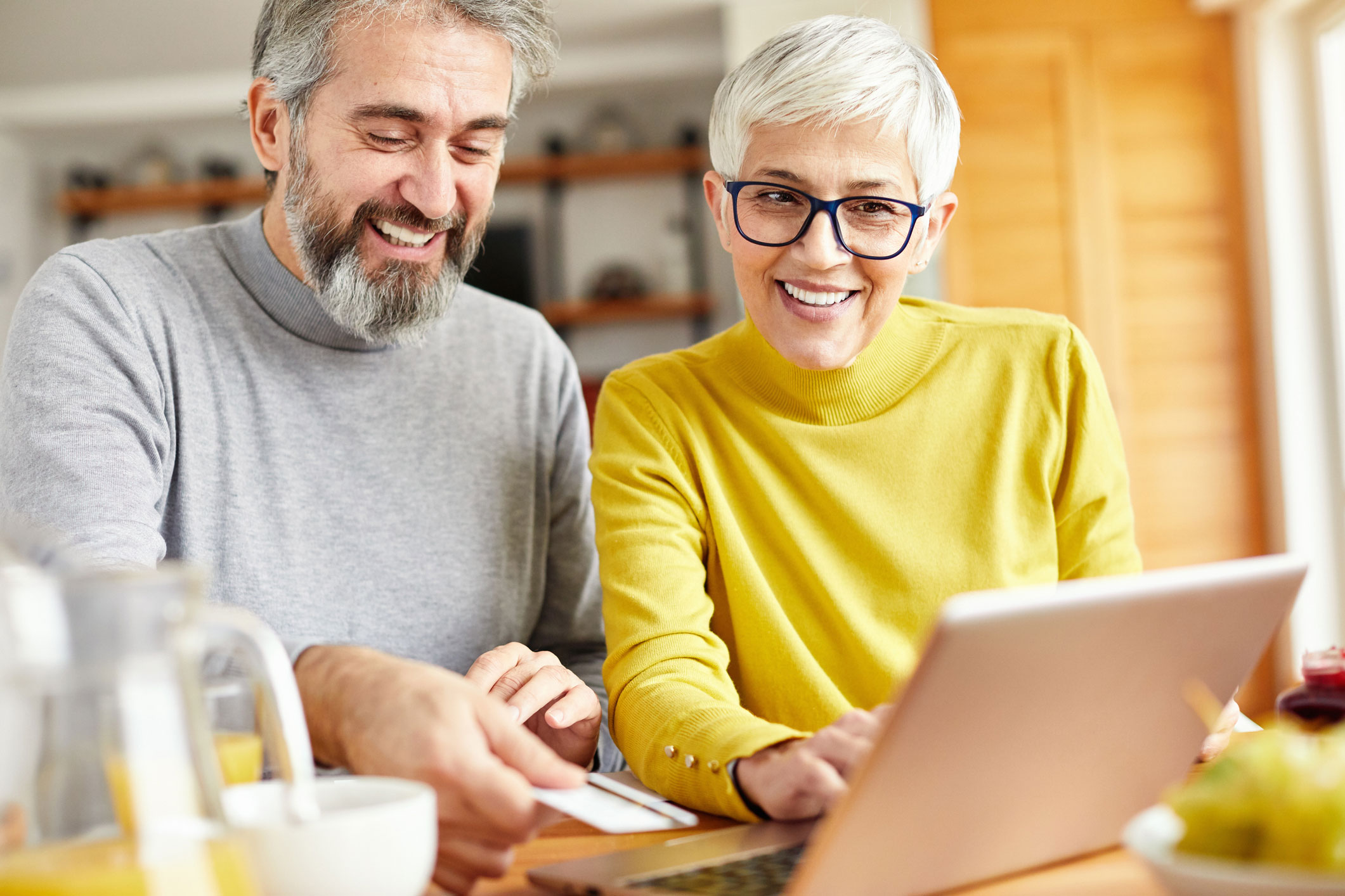 Mature couple working together on laptop.