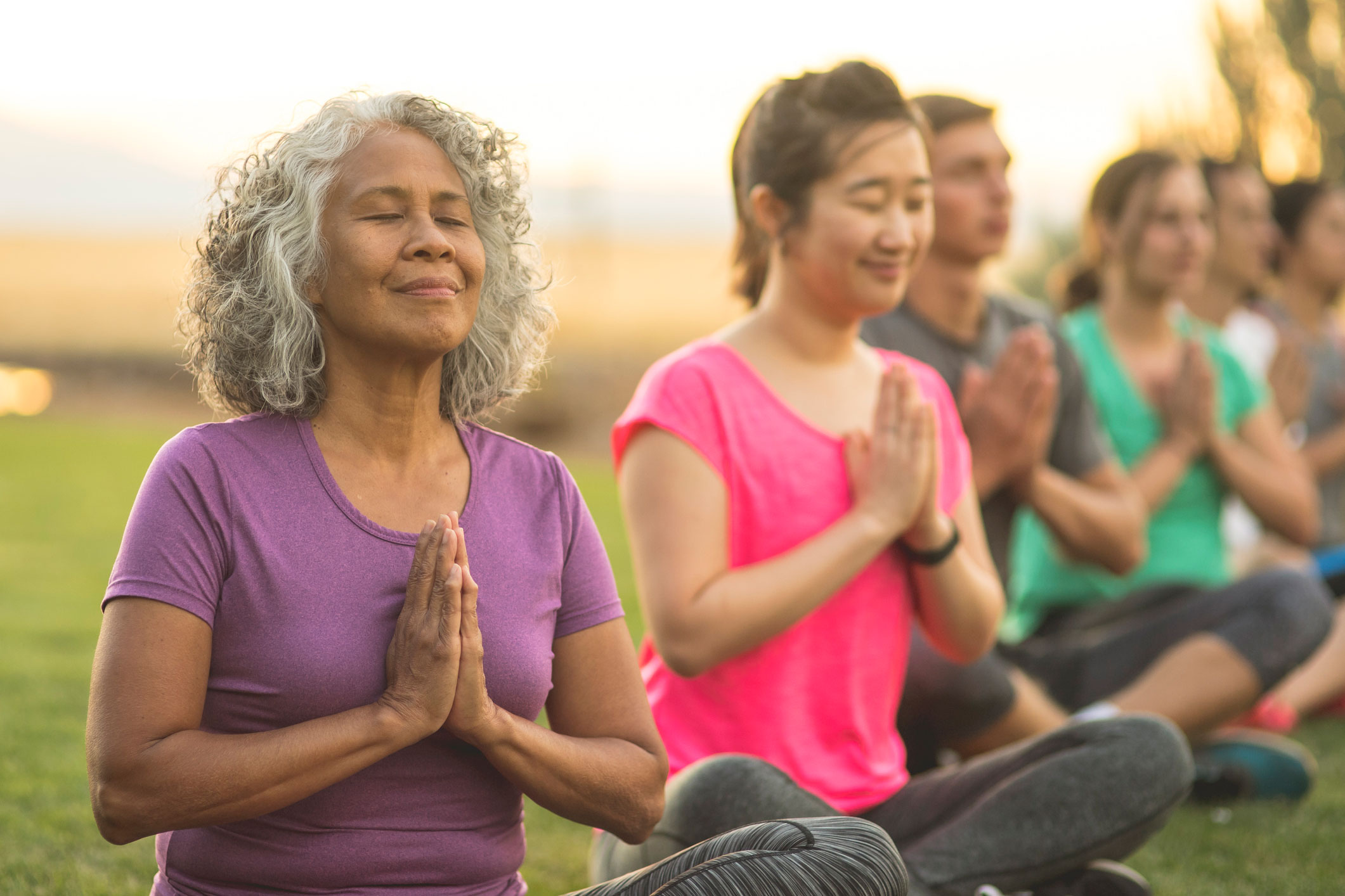 Group doing yoga with their eyes closed