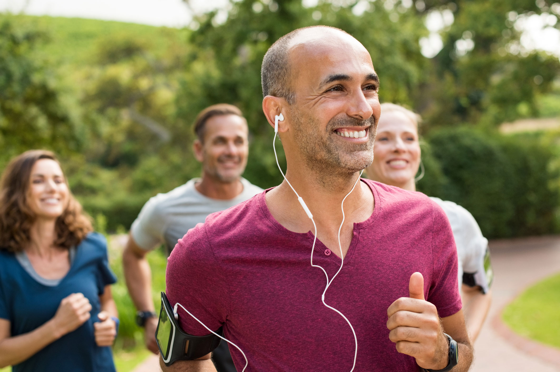 A group of joggers exercising and smiling