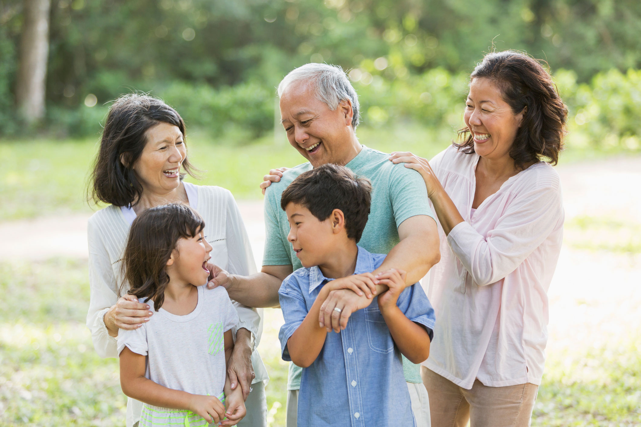 Multi-generational family having fun at the park.