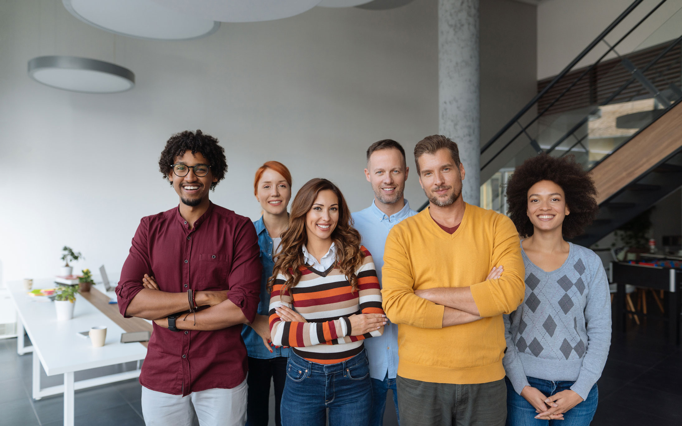 Group of young adults standing together and smiling