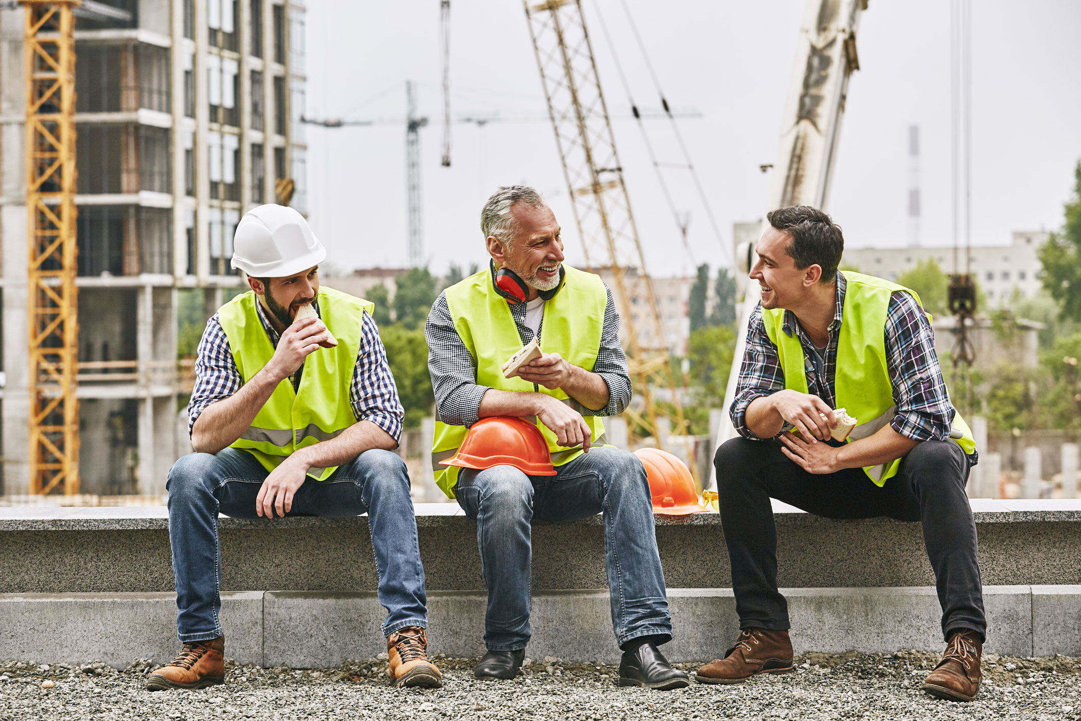A group of construction workers sitting and talking