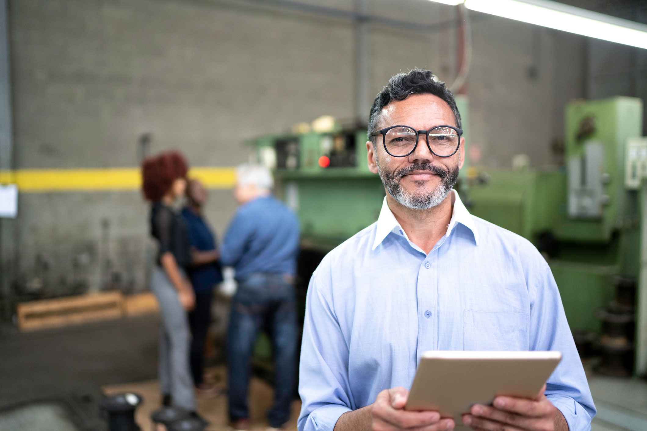 A professional man with glasses in a factory