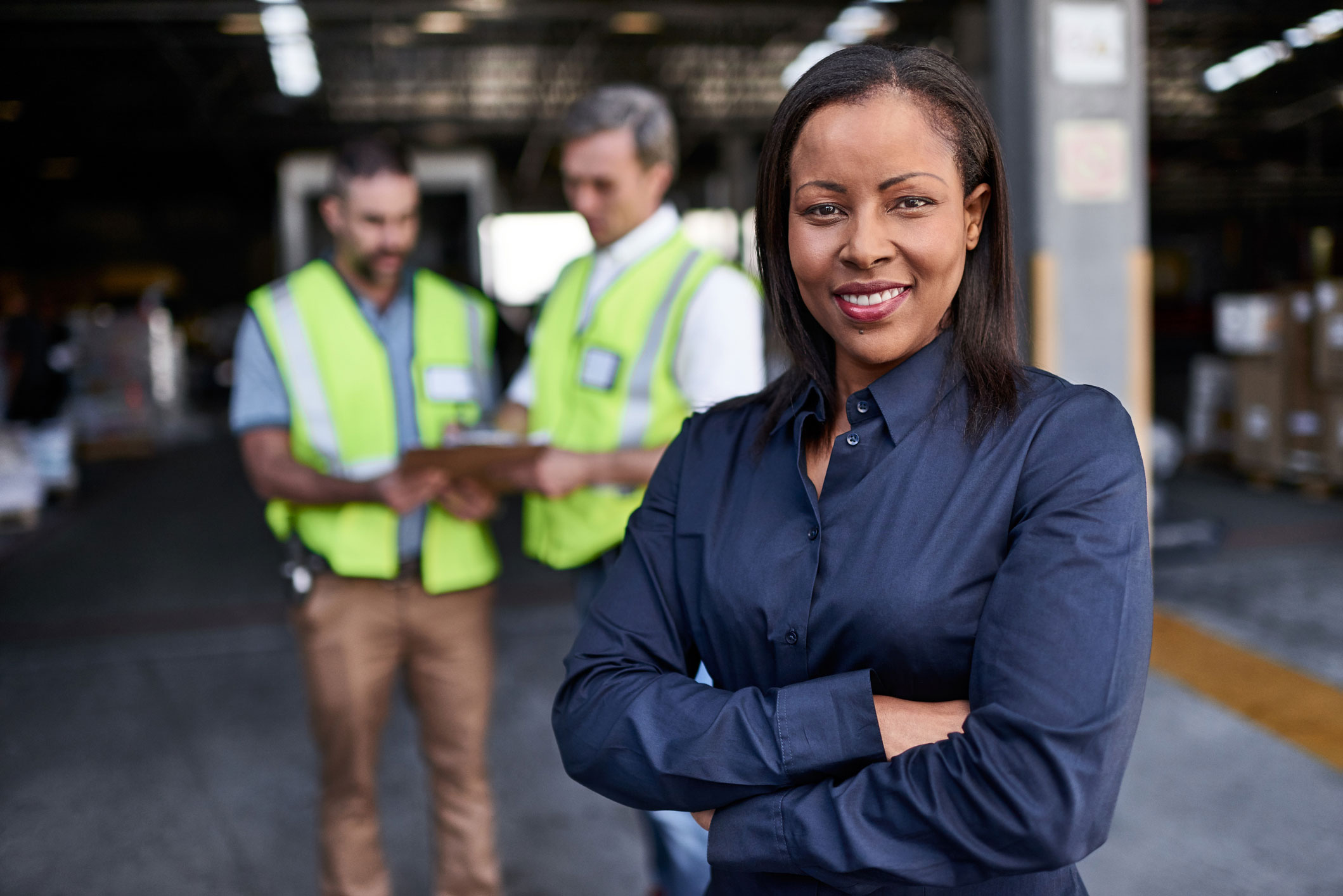 Manager at workplace standing in front of team members.