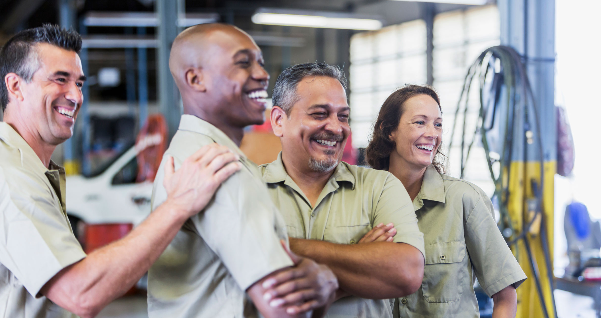 Group of factory workers celebrating