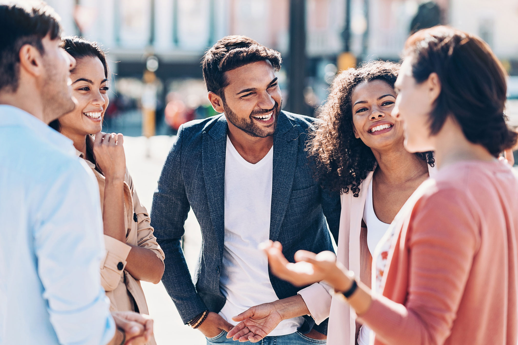 group of young adults smiling in conversation