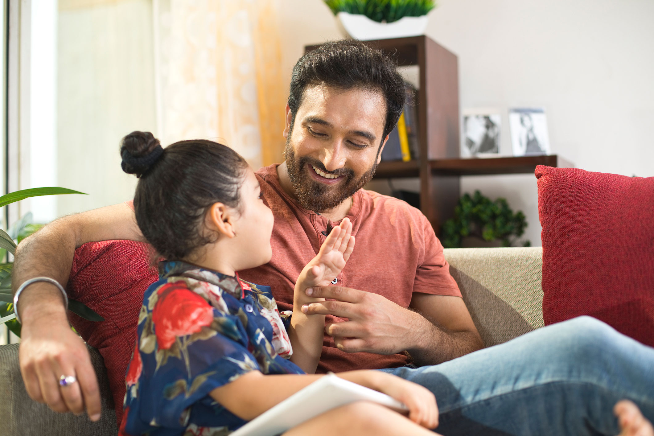 Young father sitting with daughter.