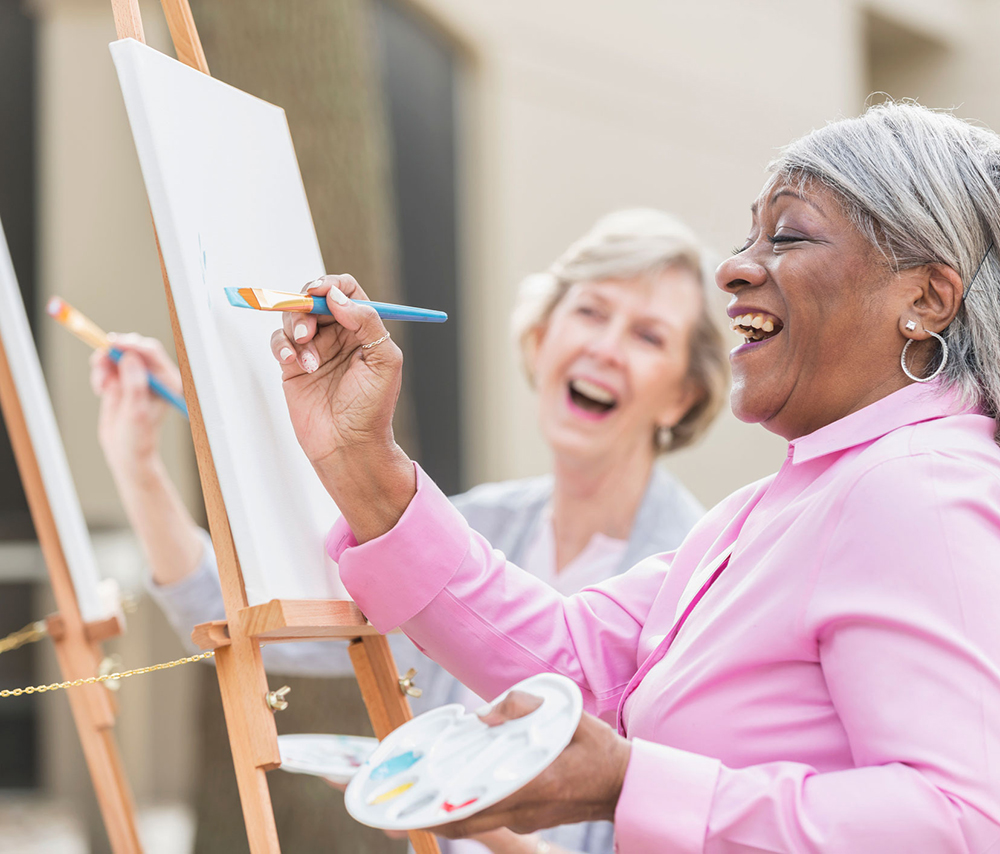 Two women drawing and laughing