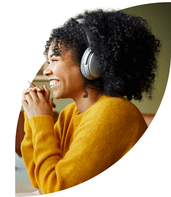 Smiling woman sitting at her desk in a web call.