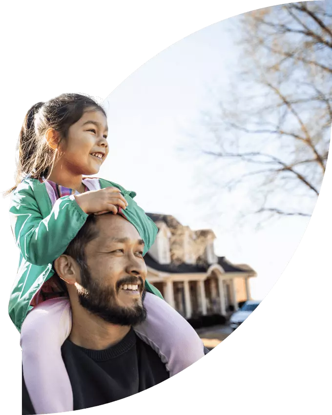 Father with daughter on his shoulders go for a stroll in the neighbourhood