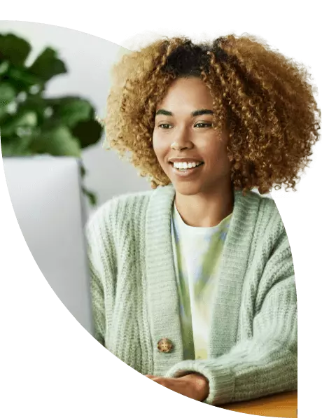 Young woman works on a computer in a home office