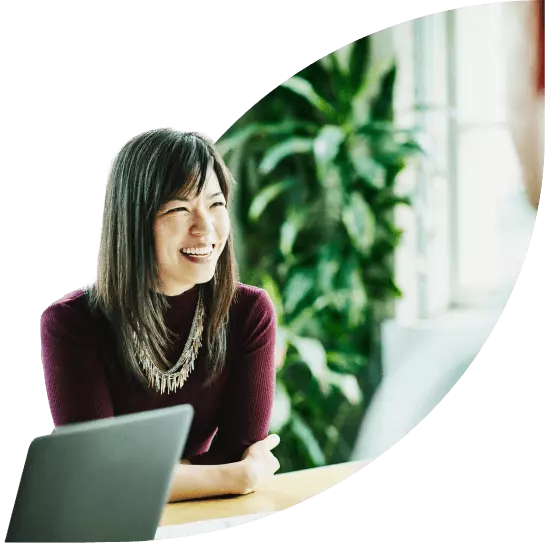 Smiling businesswoman converses with a colleague in the boardroom