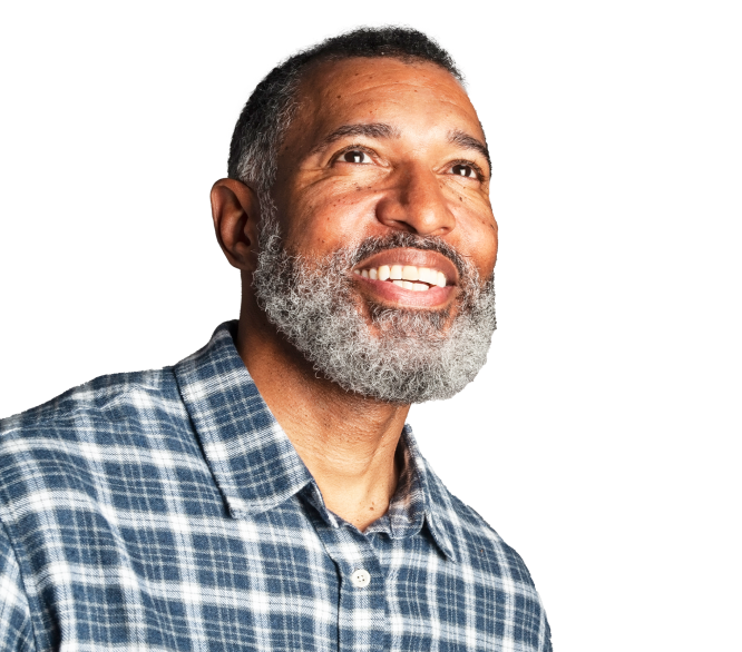 Bearded man looking up with a smile.