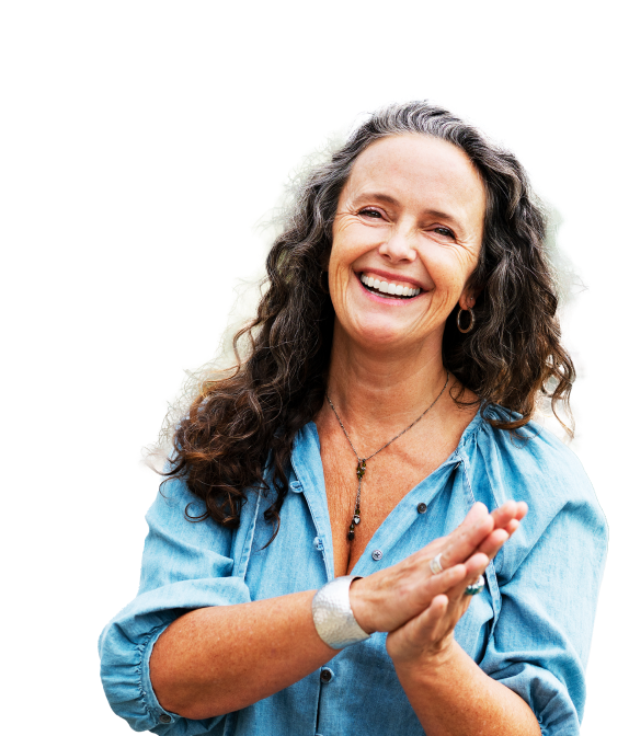 Older woman with long wavy hair laughing and clapping.
