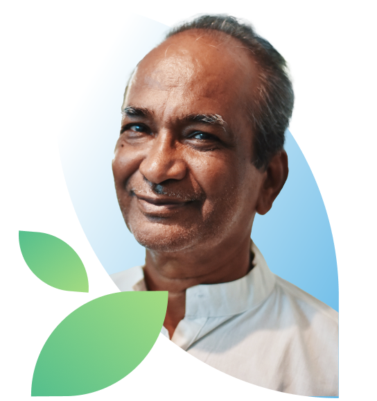 Older man leans slightly towards the camera with a calm smile.